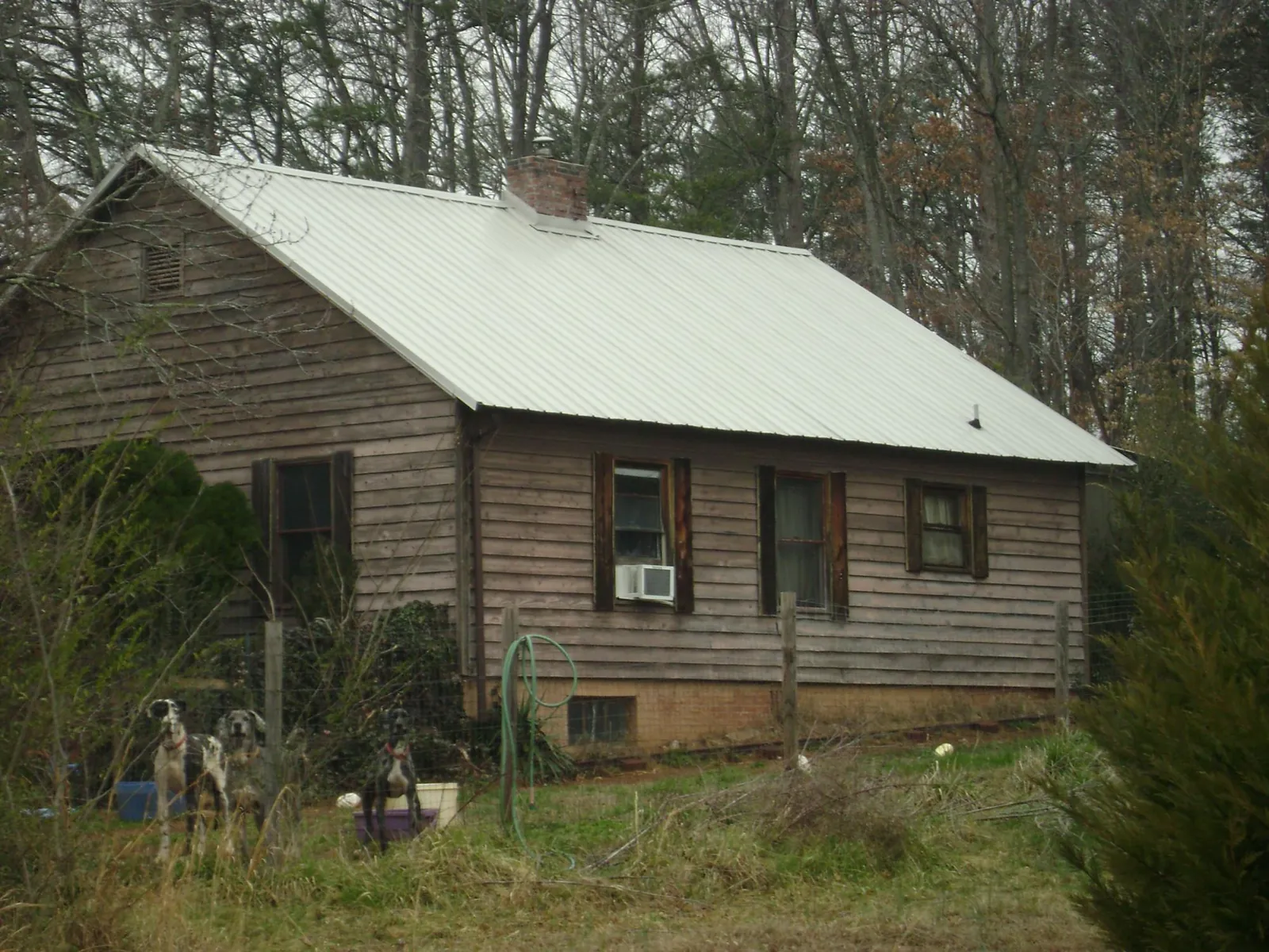White metal roof on an old wood sided farmhouse, from a Metal Roof Installation job in Cold Spring